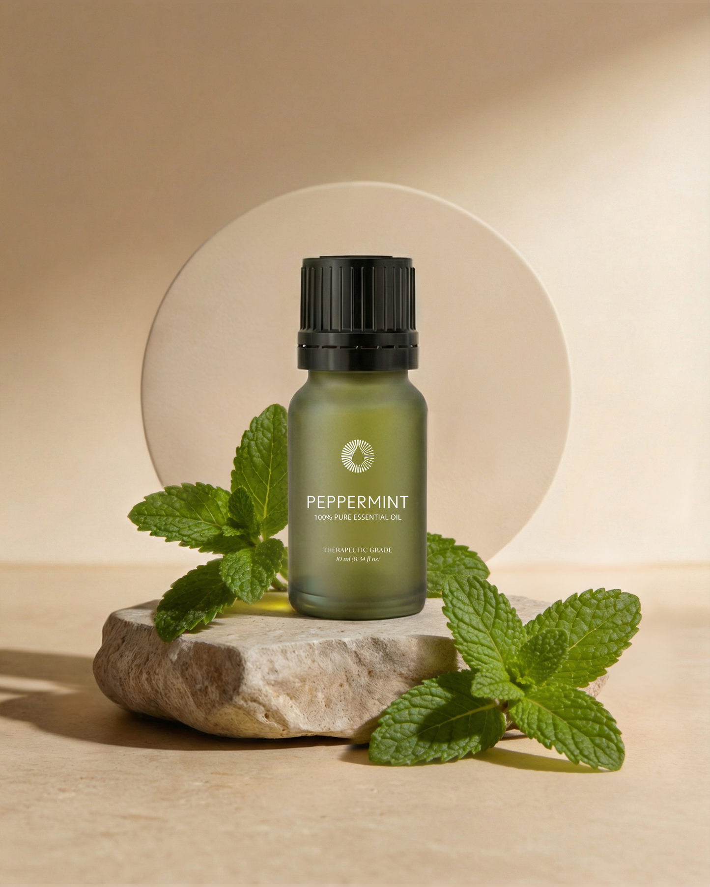 organic peppermint essential oil aromatherapy bottle with fresh mint leaves on a stone surface