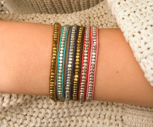 Close-up of a wrist wearing multiple colorful bracelets Handmade in India
