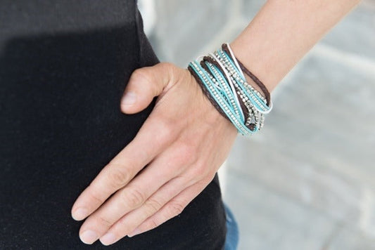 Turquoise and brown beaded wrap bracelet worn on wrist — ethically sourced boho jewelry handmade in India