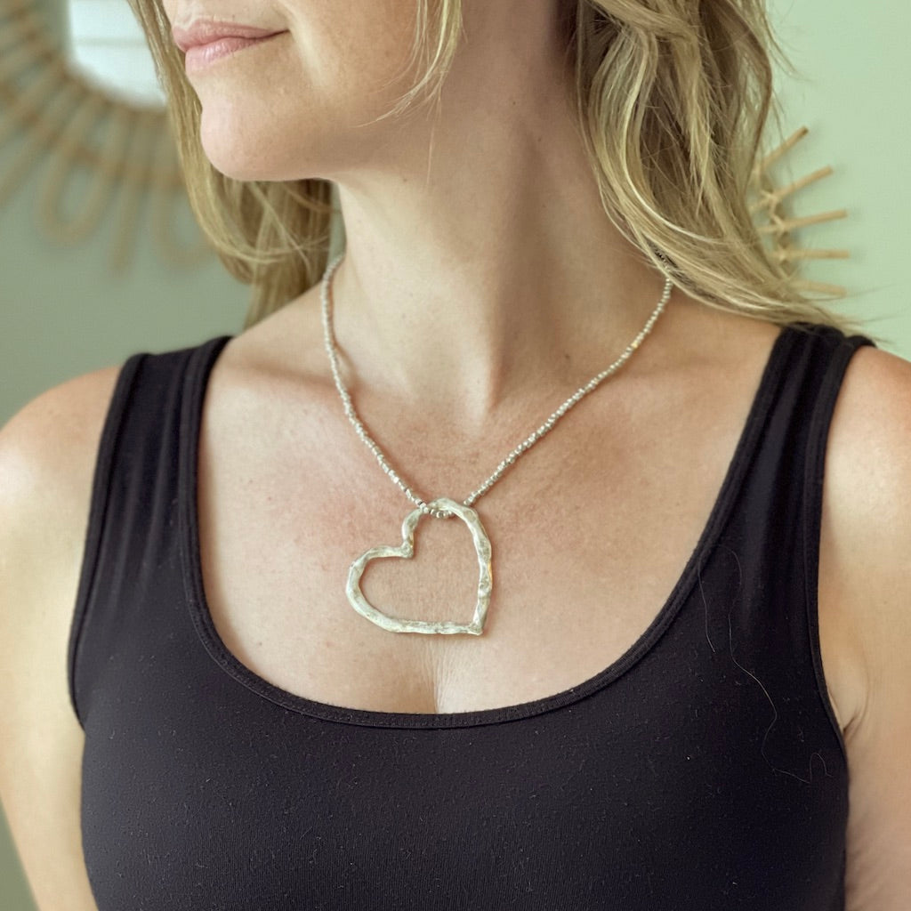 Silver plate open heart necklace Bali handmade artisan jewelry on woman