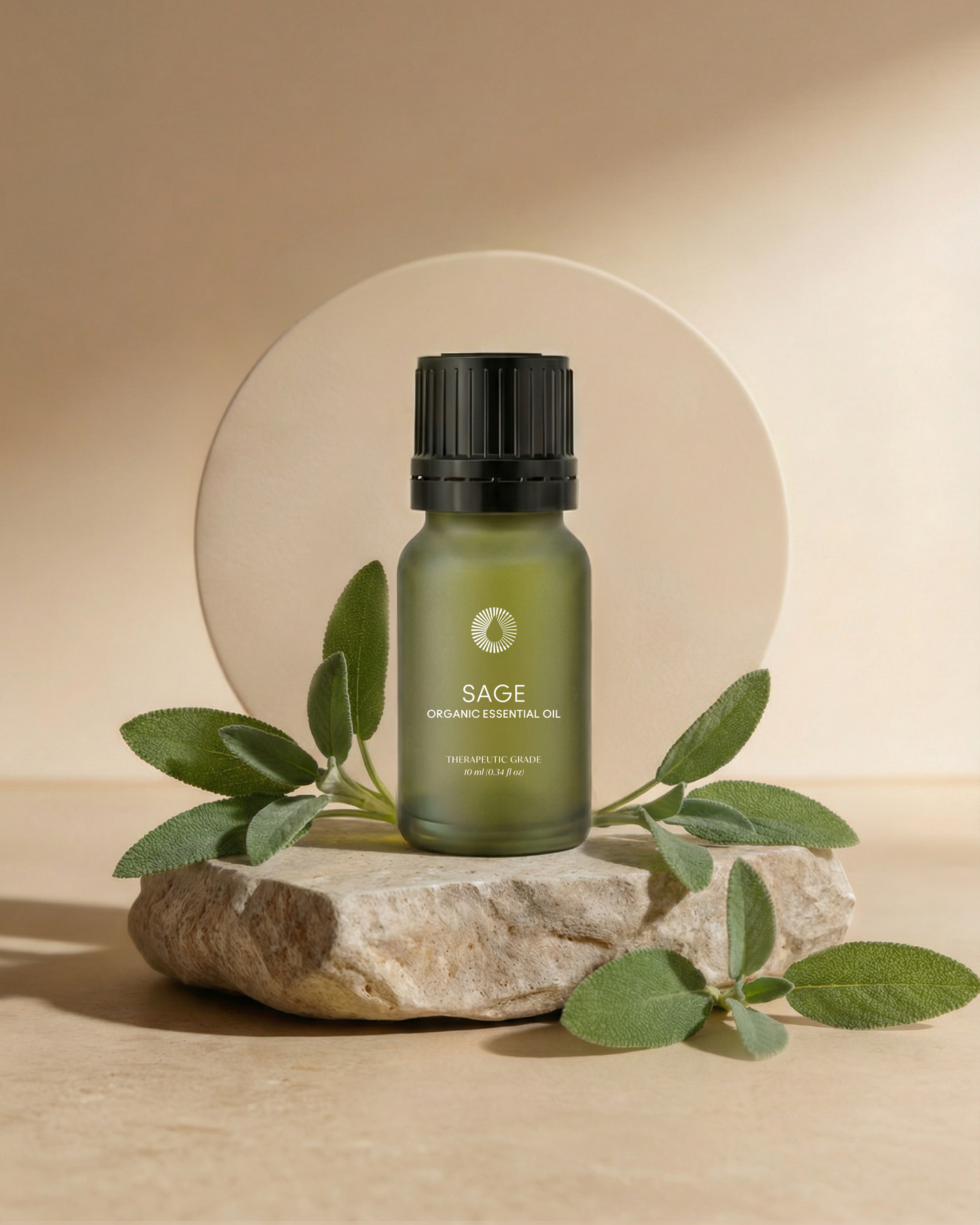 sage essential oil aromatherapy bottle on a stone surface with leaves around, against a beige background