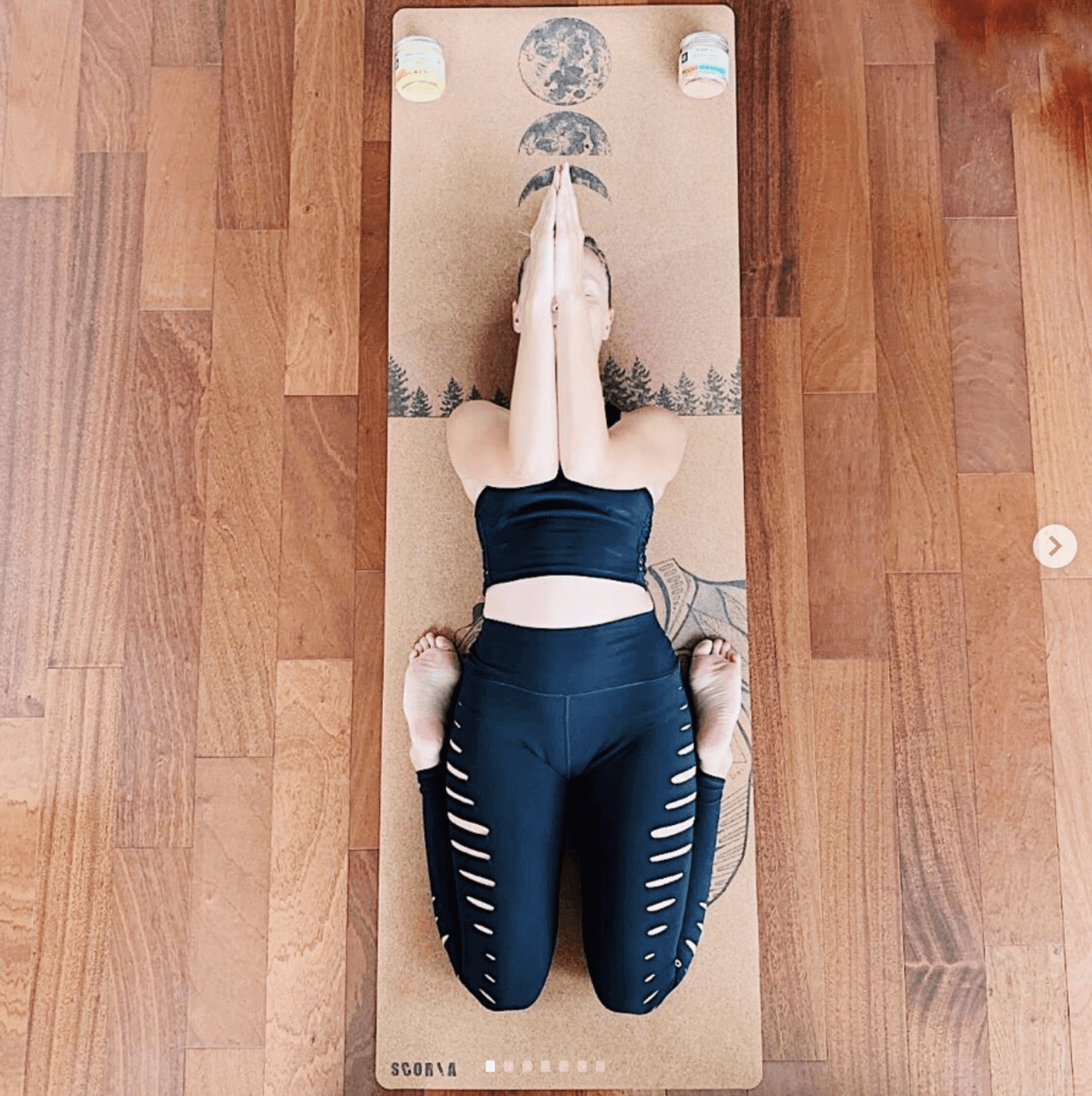 woman doing a yoga pose on a cork yoga mat with bear design