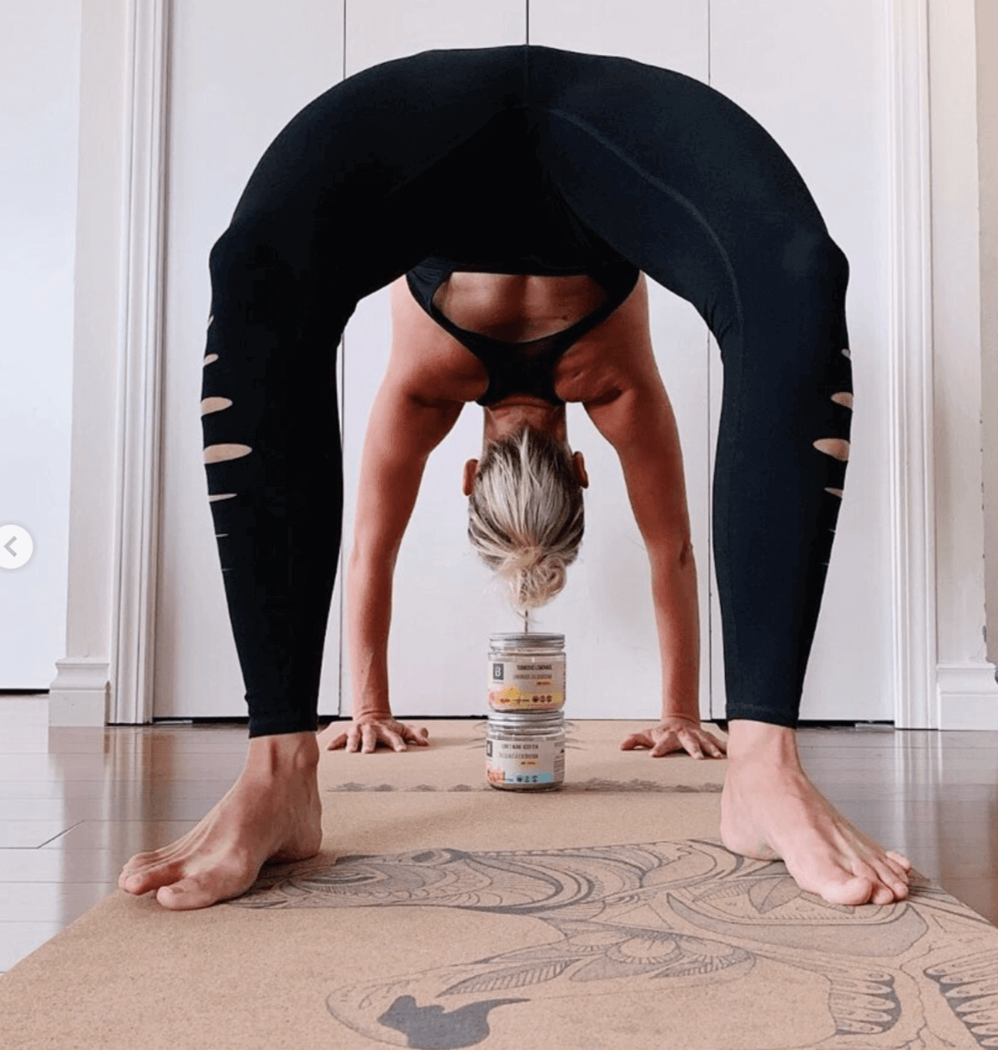 woman doing a yoga post on a cork yoga mat with bear design in a home setting