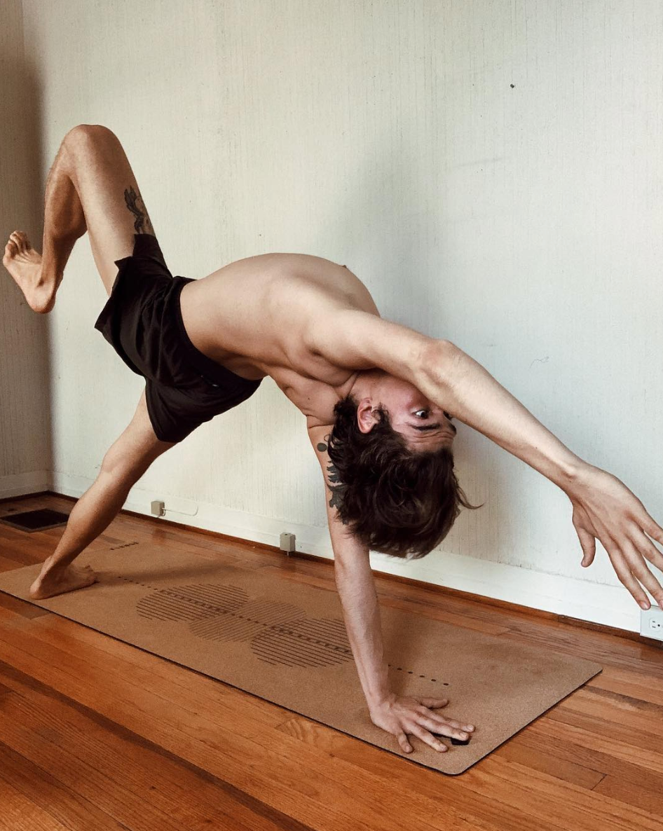 man practicing yoga on a cork yoga mat with geometric design