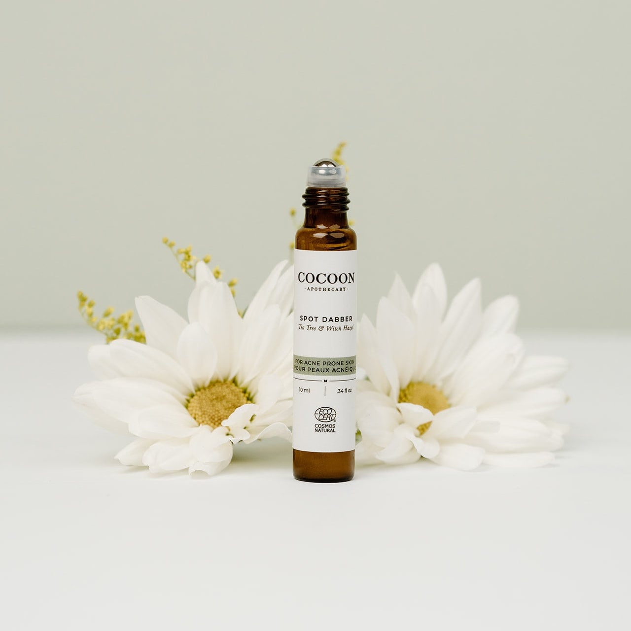 Spot Dabber for Acne Prone Skin bottle with white flowers on a light background