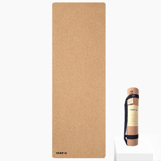 Cork yoga mat with carrying strap on a white background