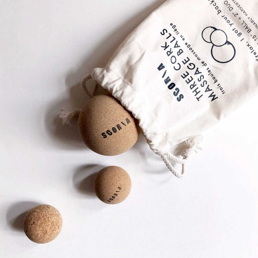 Cork massage balls with a branded bag on a white background