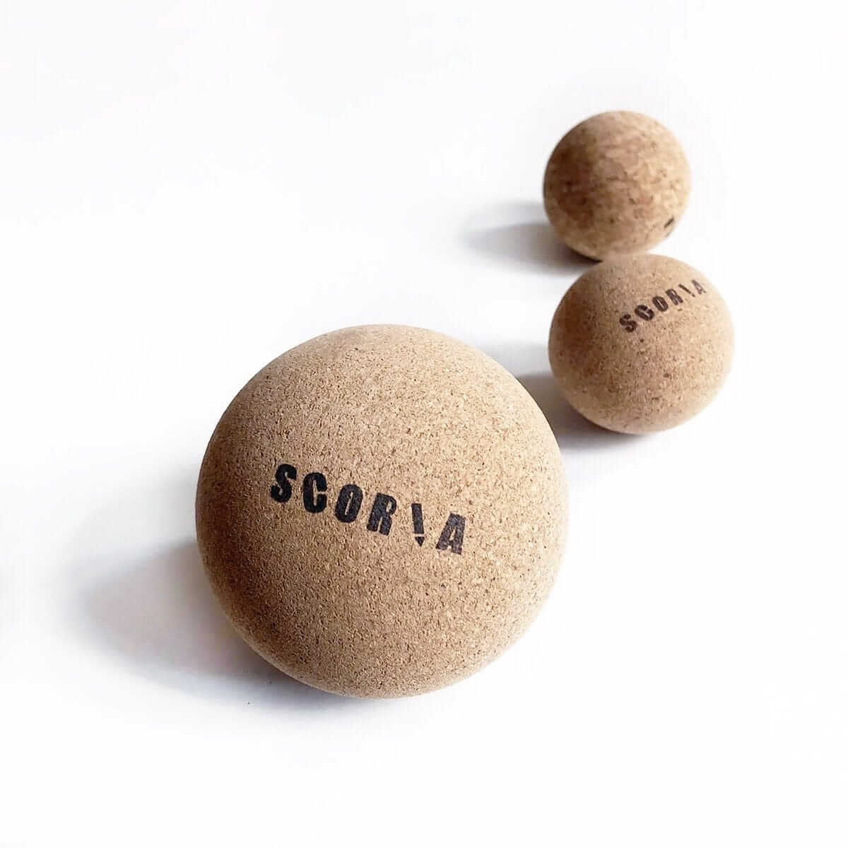 Three cork balls with branding on a white background