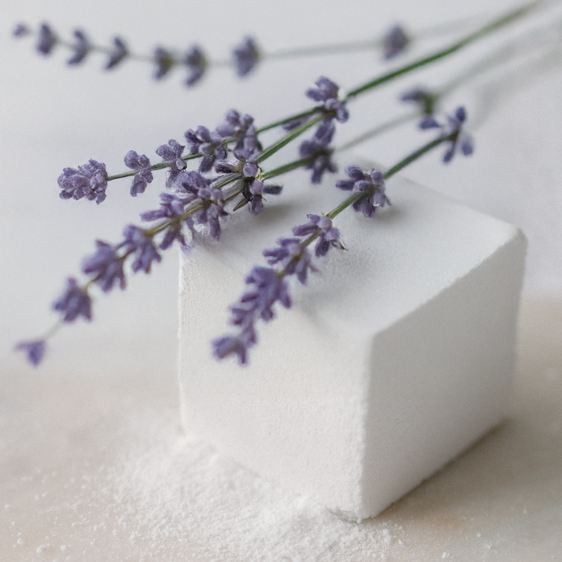 Lavender flowers on a Lavandin Bath Cube with a blurred background