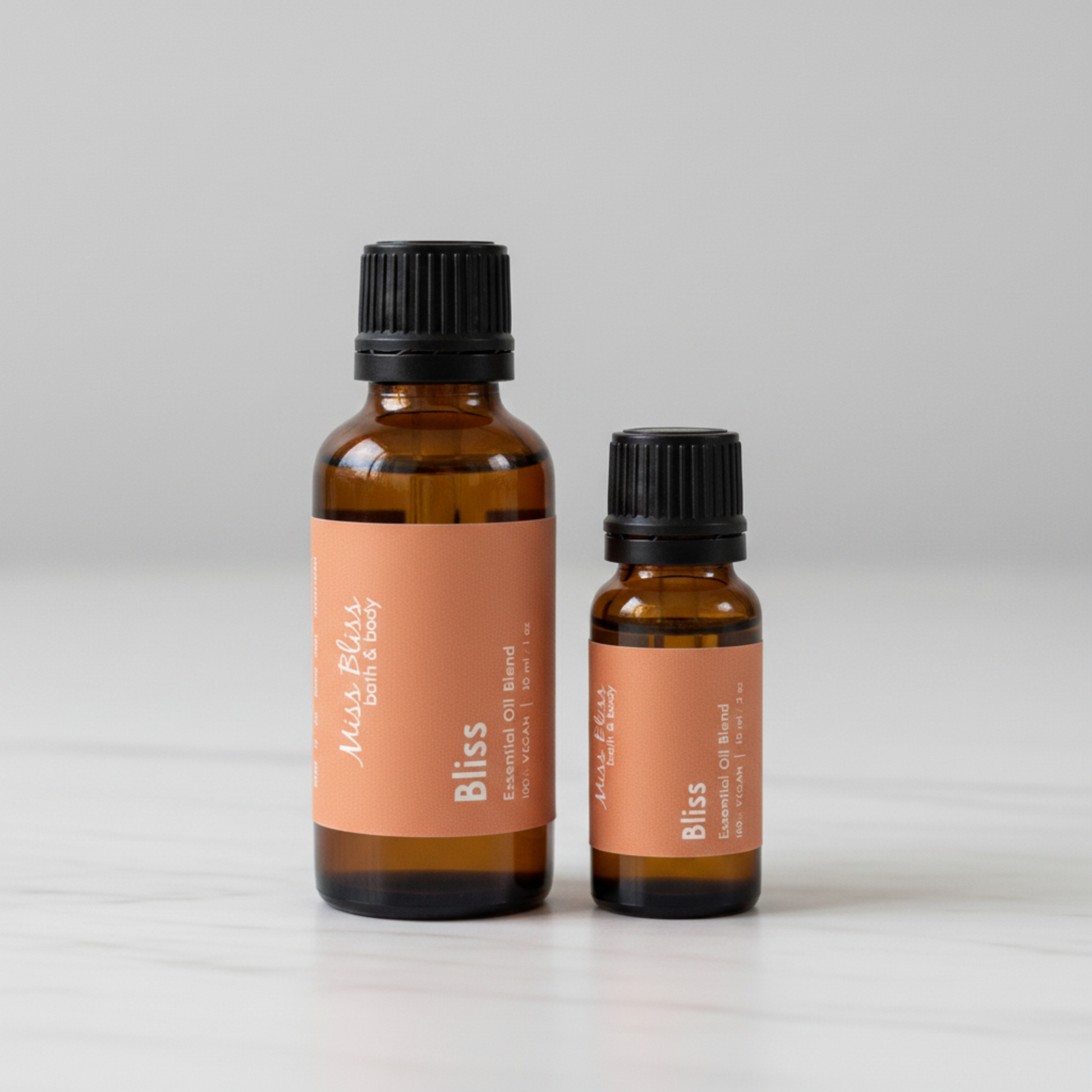 Bliss Essential Oil Blend — 30ml and 15ml amber glass bottles with orange labels, 100% pure essential oils, handcrafted in Canada