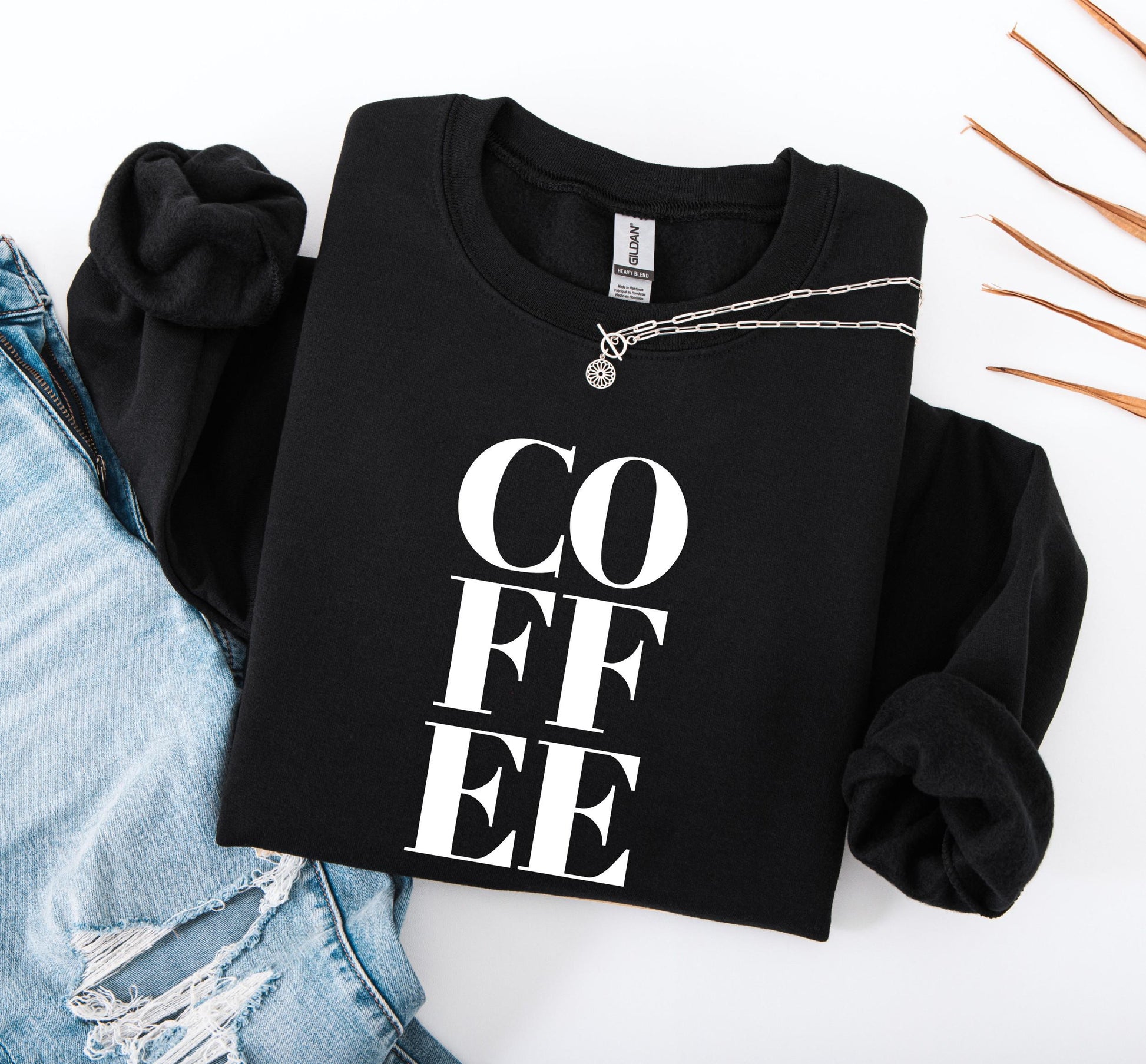 COFFEE sweatshirt close-up showing soft fabric and bold graphic print detail in black