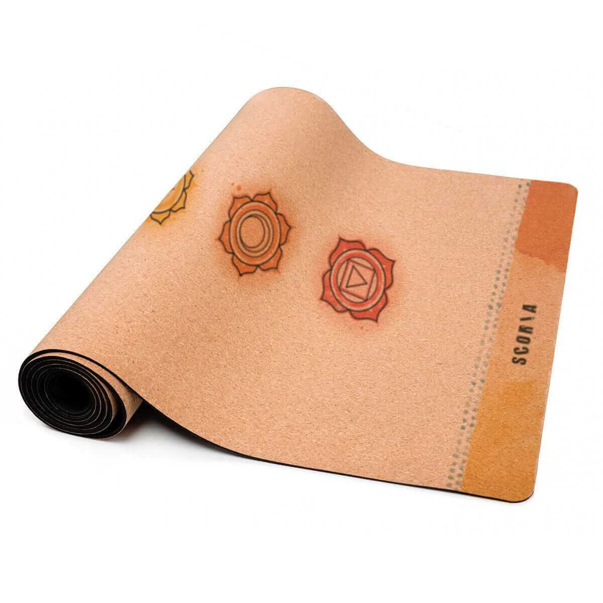 Cork yoga mat with chakra symbols and ' branding on a white background
