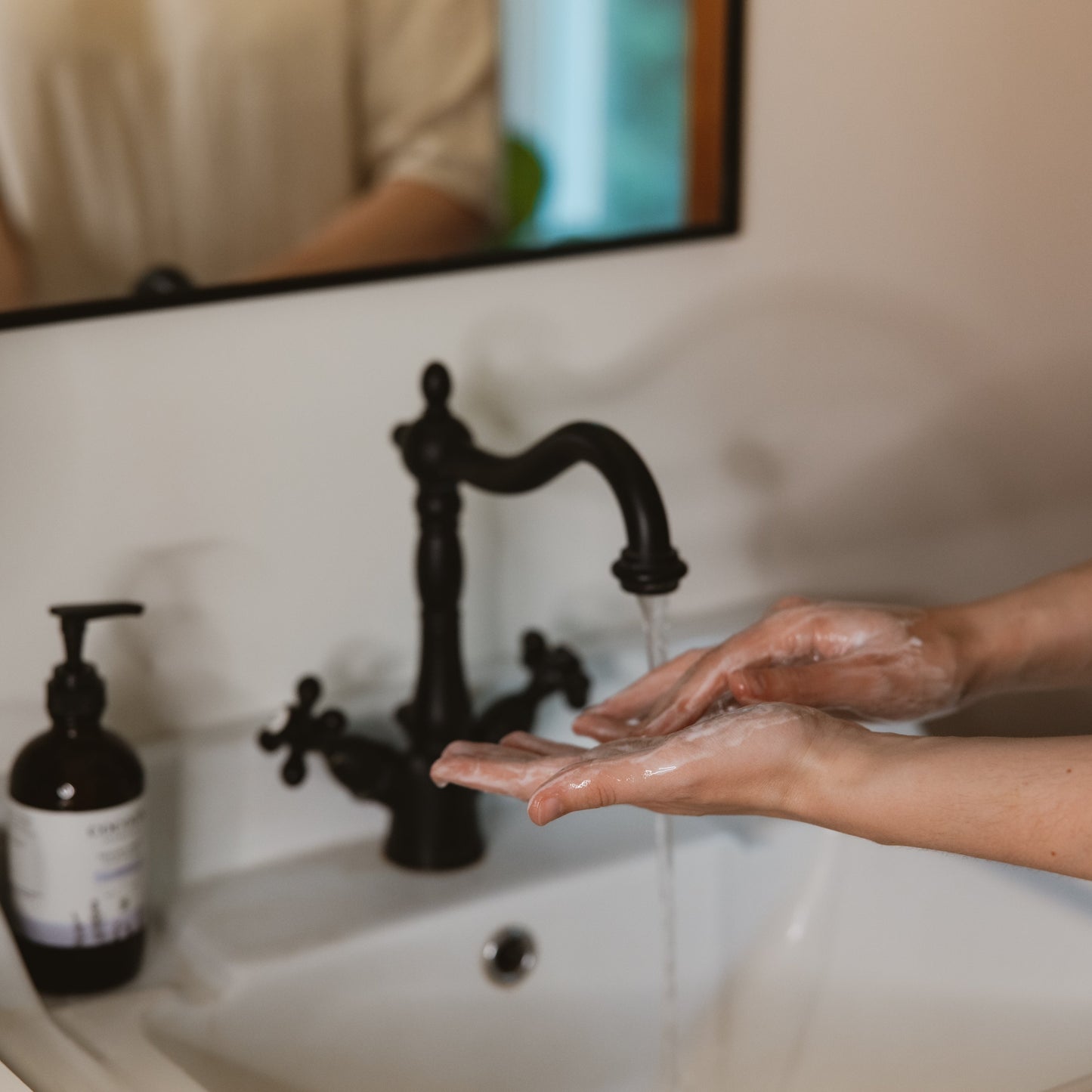 Cocoon Apothecary Touchy Feely liquid hand soap styled on surface