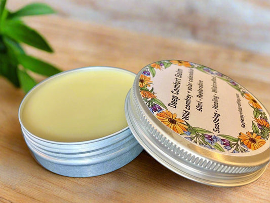 Comfort Balm tin with floral label on a wooden surface