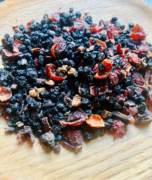 Dried berries and spices on a wooden surface