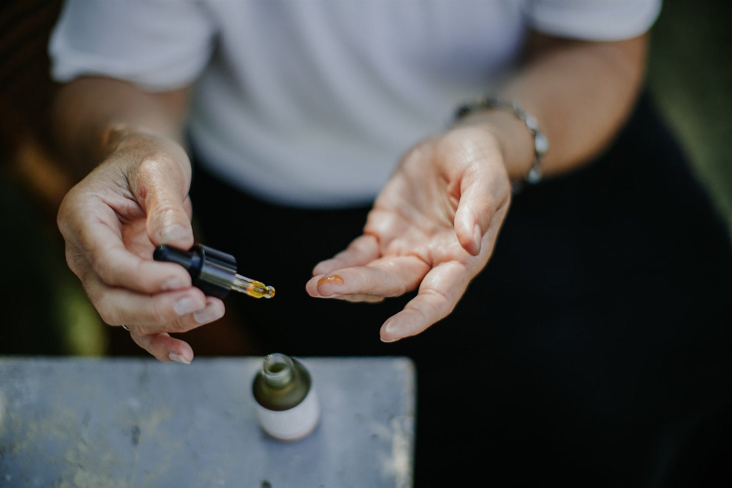 Replenish eye serum close-up showing dropper and amber glass bottle detail