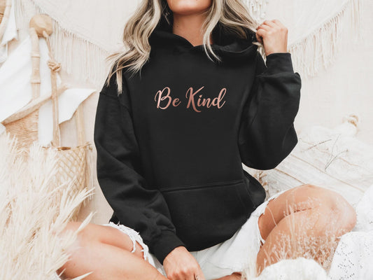 Uplifting "Be Kind" hoodie in rose gold for warm-hearted and compassionate women in black