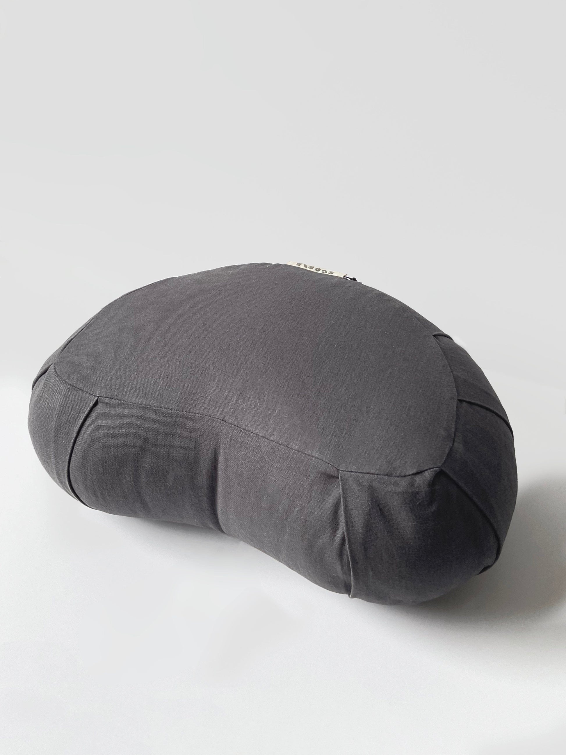 Gray yoga bolster pillow on a light gray background