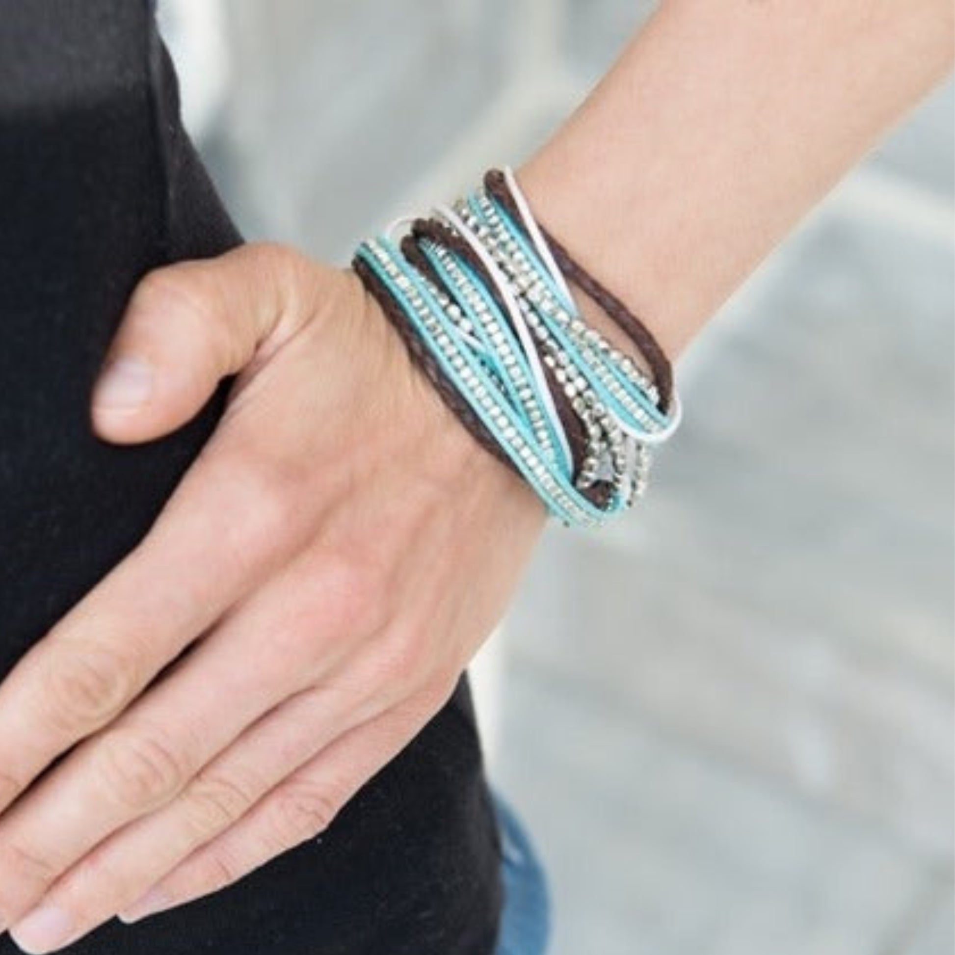 Turquoise and brown beaded wrap bracelet worn on wrist — ethically sourced boho jewelry handmade in India