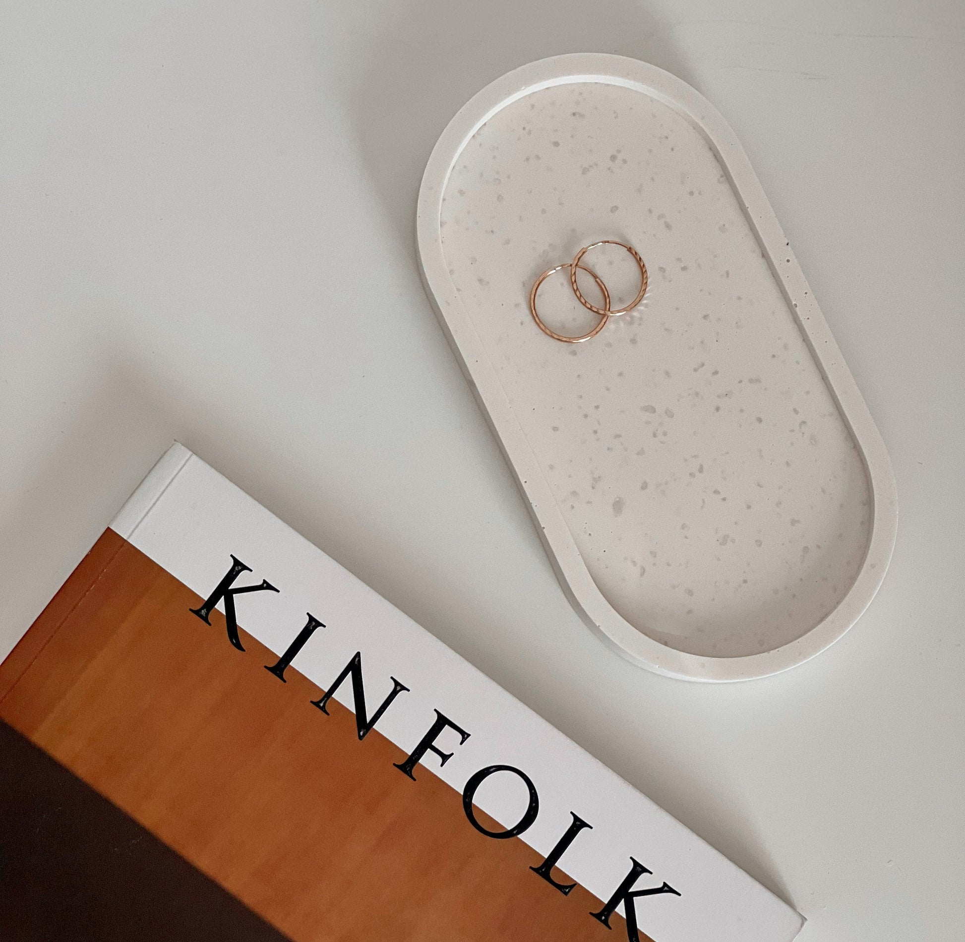 Jesmonite oval trinket tray styled with jewelry