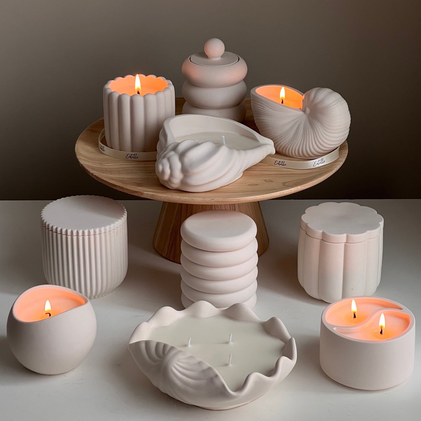 Artisan clam shell candle in jesmonite vessel lit
