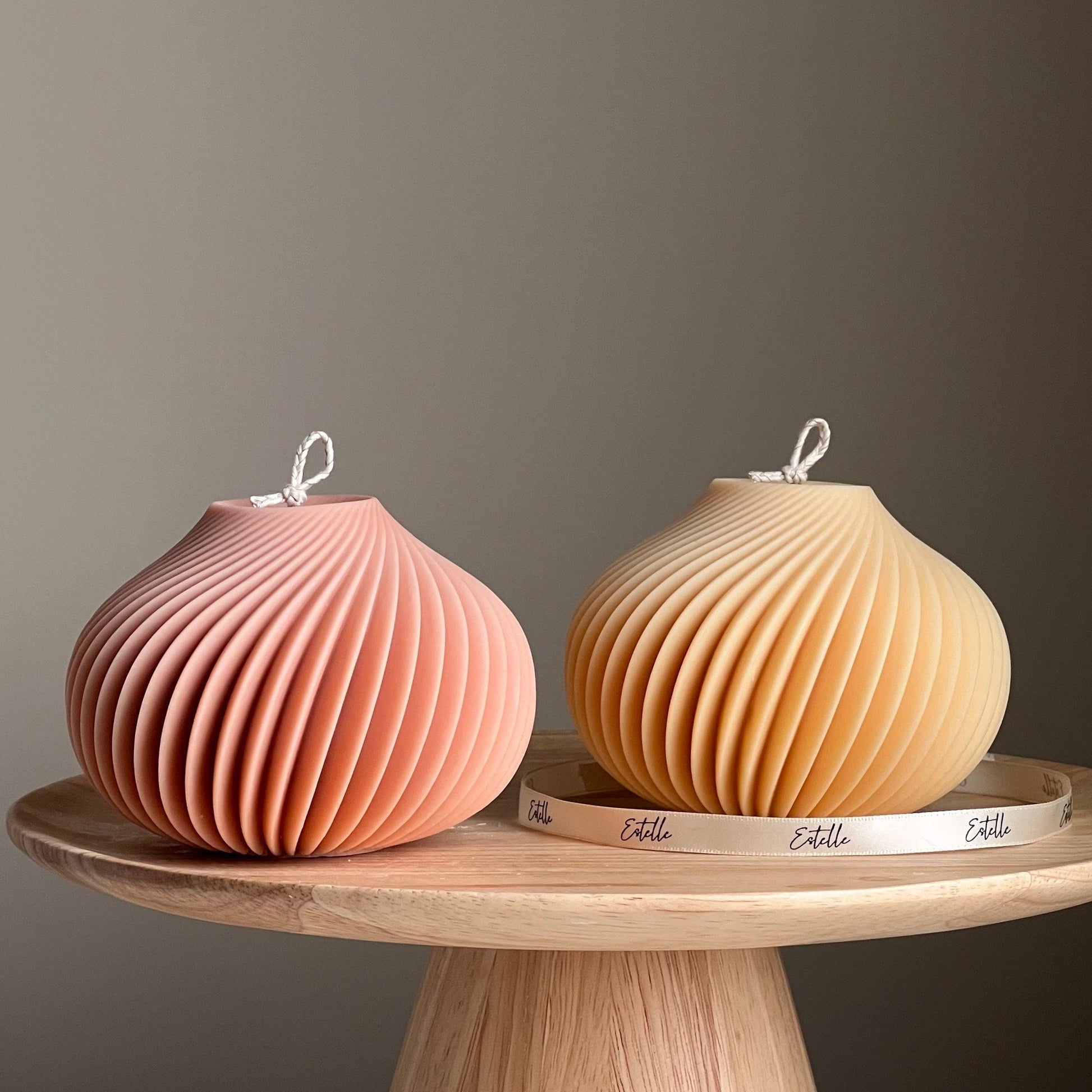 Spiral vase soy candle in two colors on display