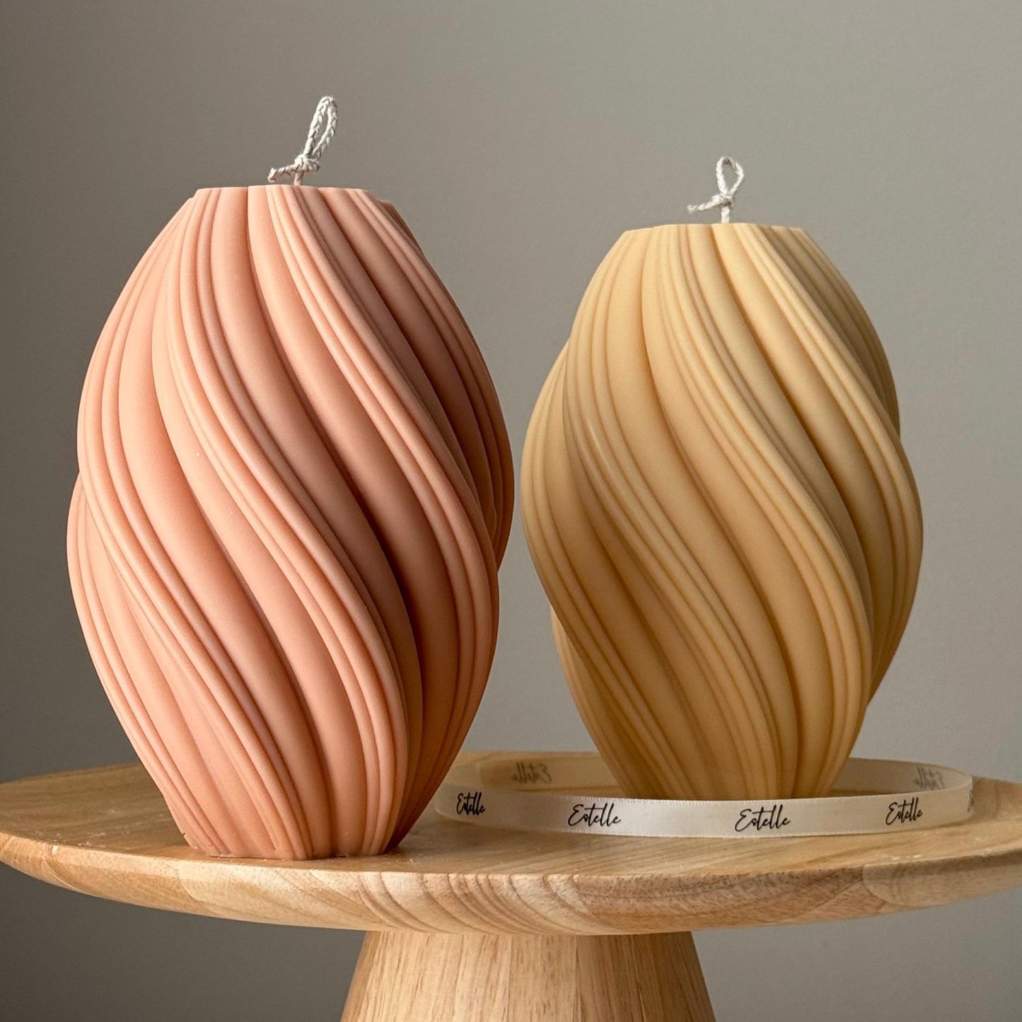 Tall swirl soy candle in two colors on display