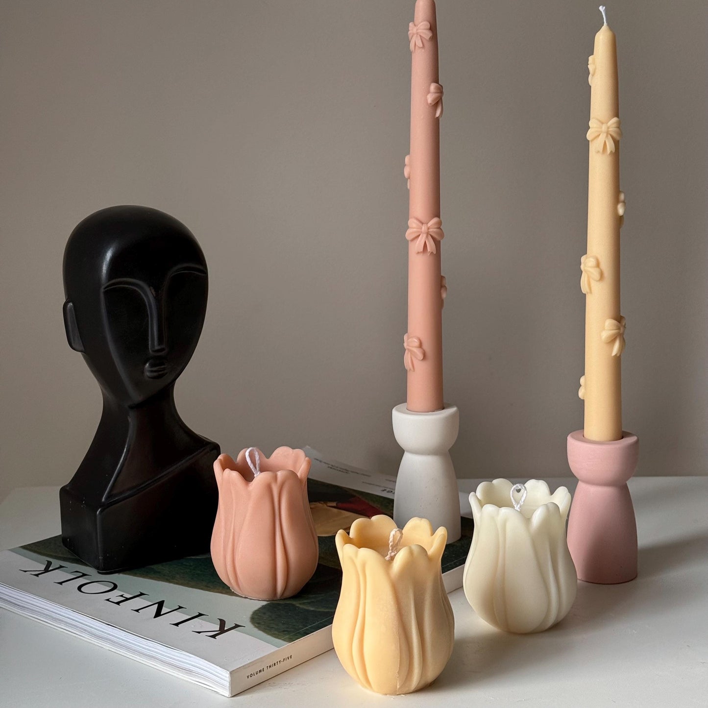 Tulip soy pillar candle in two colors on display lifestyle shot