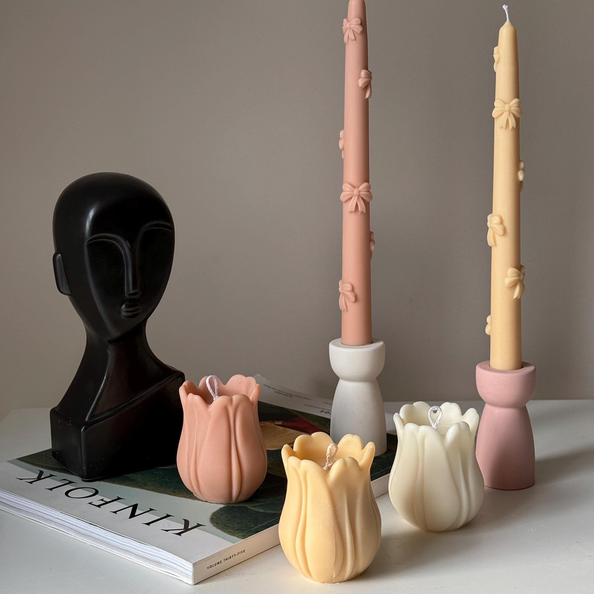 Tulip soy pillar candle in two colors on display lifestyle shot
