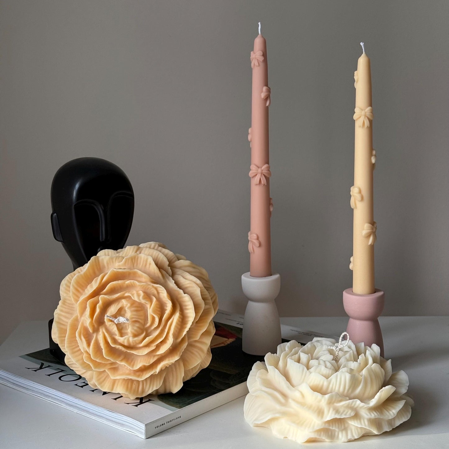 Large peony soy pillar candle in mellow and cream color lifestyle display