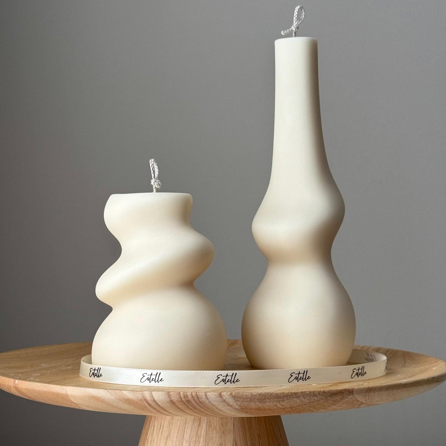 Irregular soy pillar candle duo in cream color on display