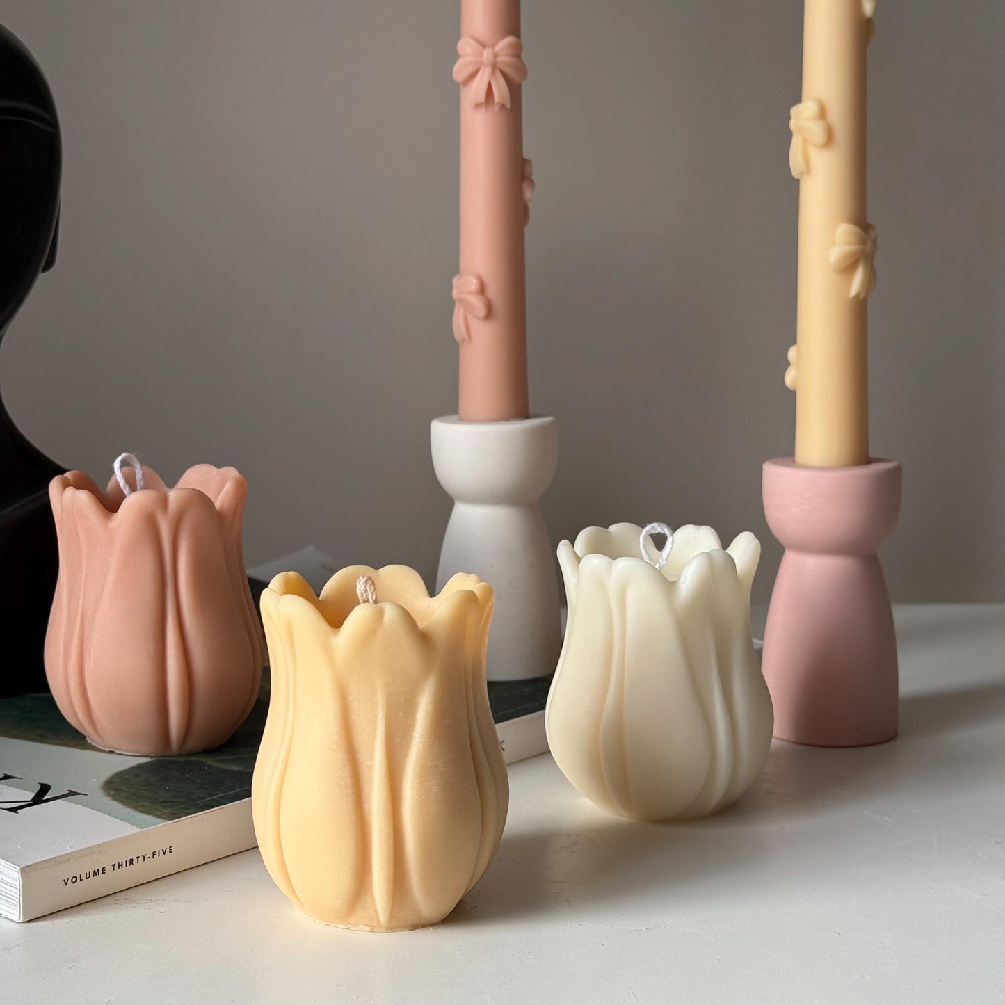 Tulip soy pillar candle in three colors on display
