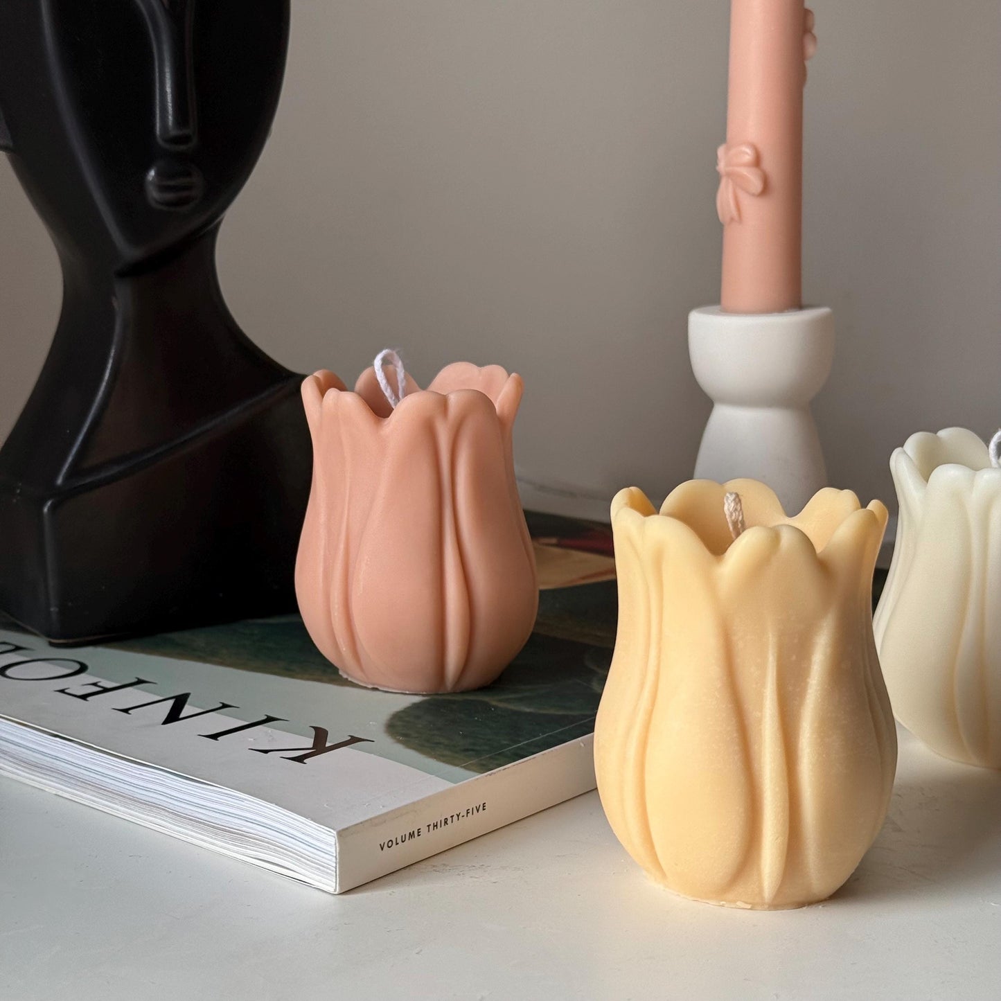 Tulip soy pillar candle in two colors on display