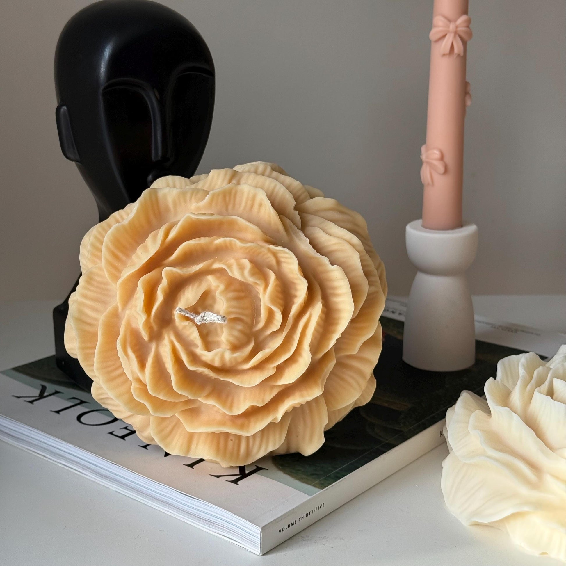 Large peony soy pillar candle in mellow color on display
