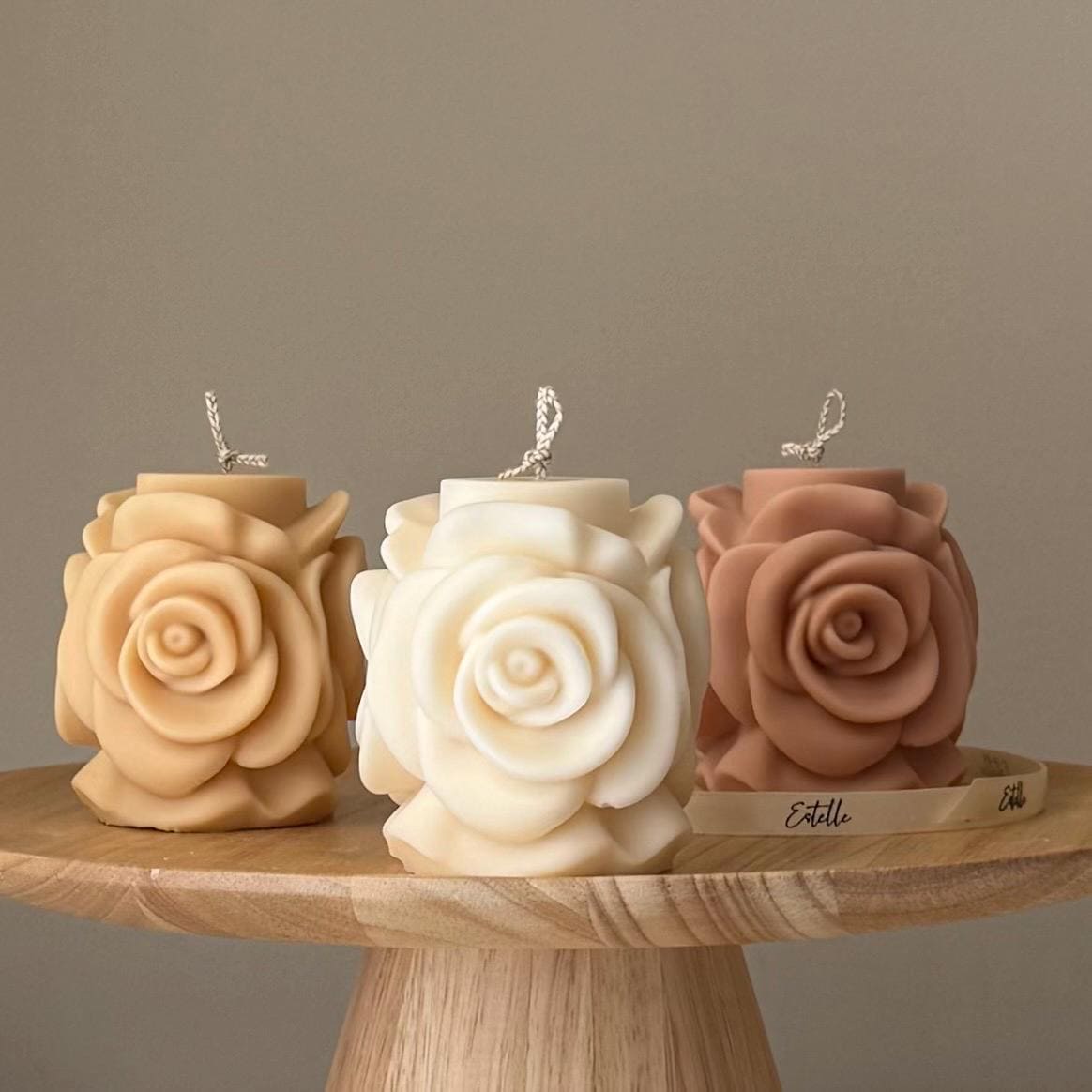 Rose flower soy pillar candle in three colors on display