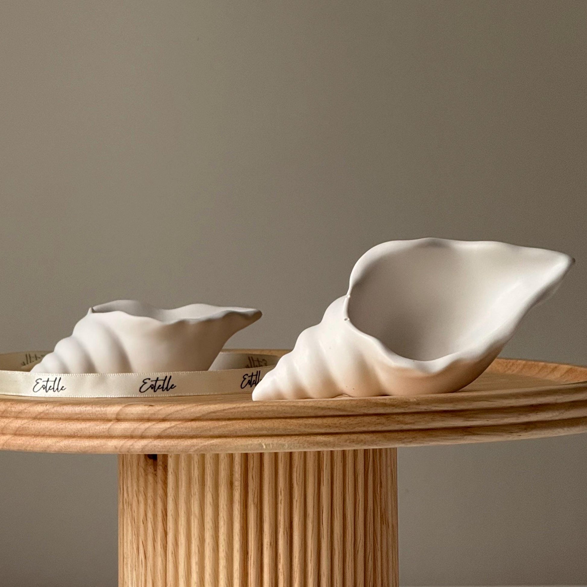 Handmade conch shell jesmonite trinket tray on a neutral background