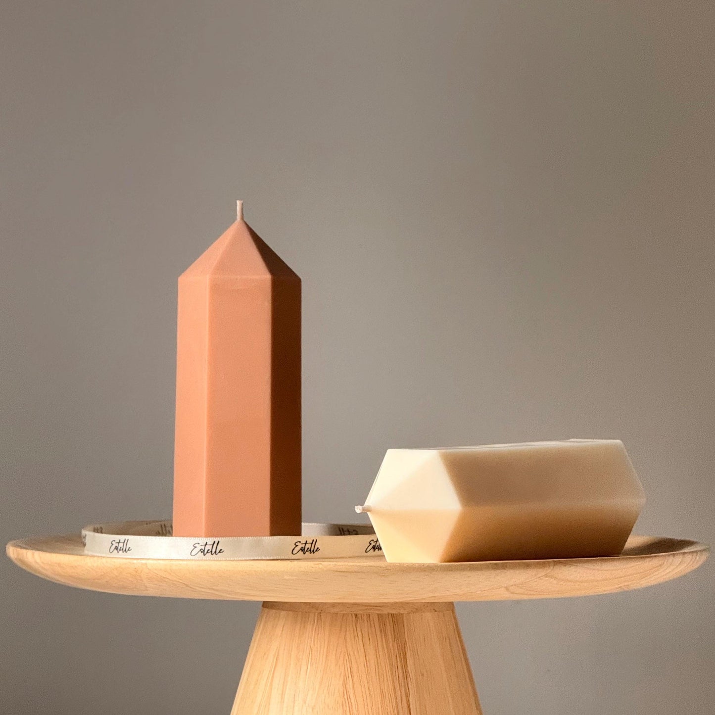 Greko peak ribbed pillar taper soy candle in two colors on display
