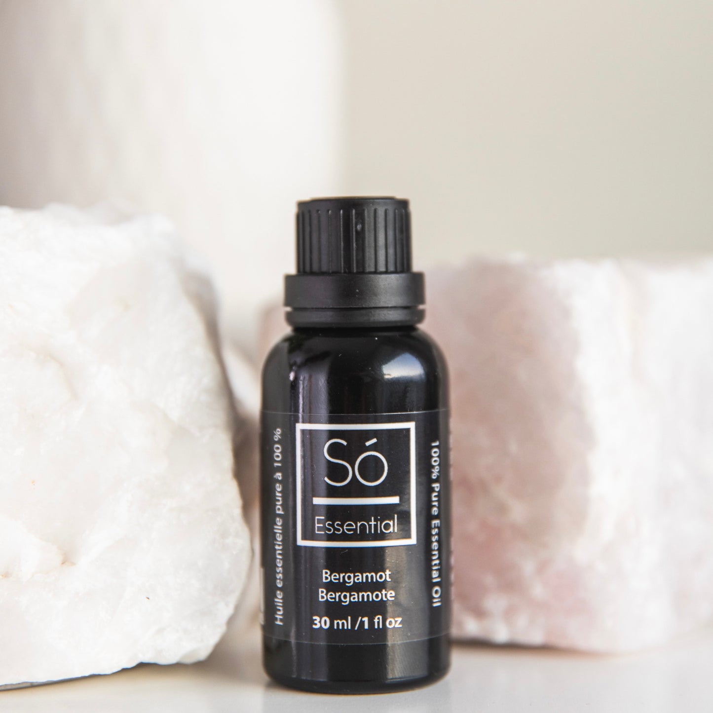 Black Bergamot essential oil bottle labeled 'Sö Essential' on a light background
