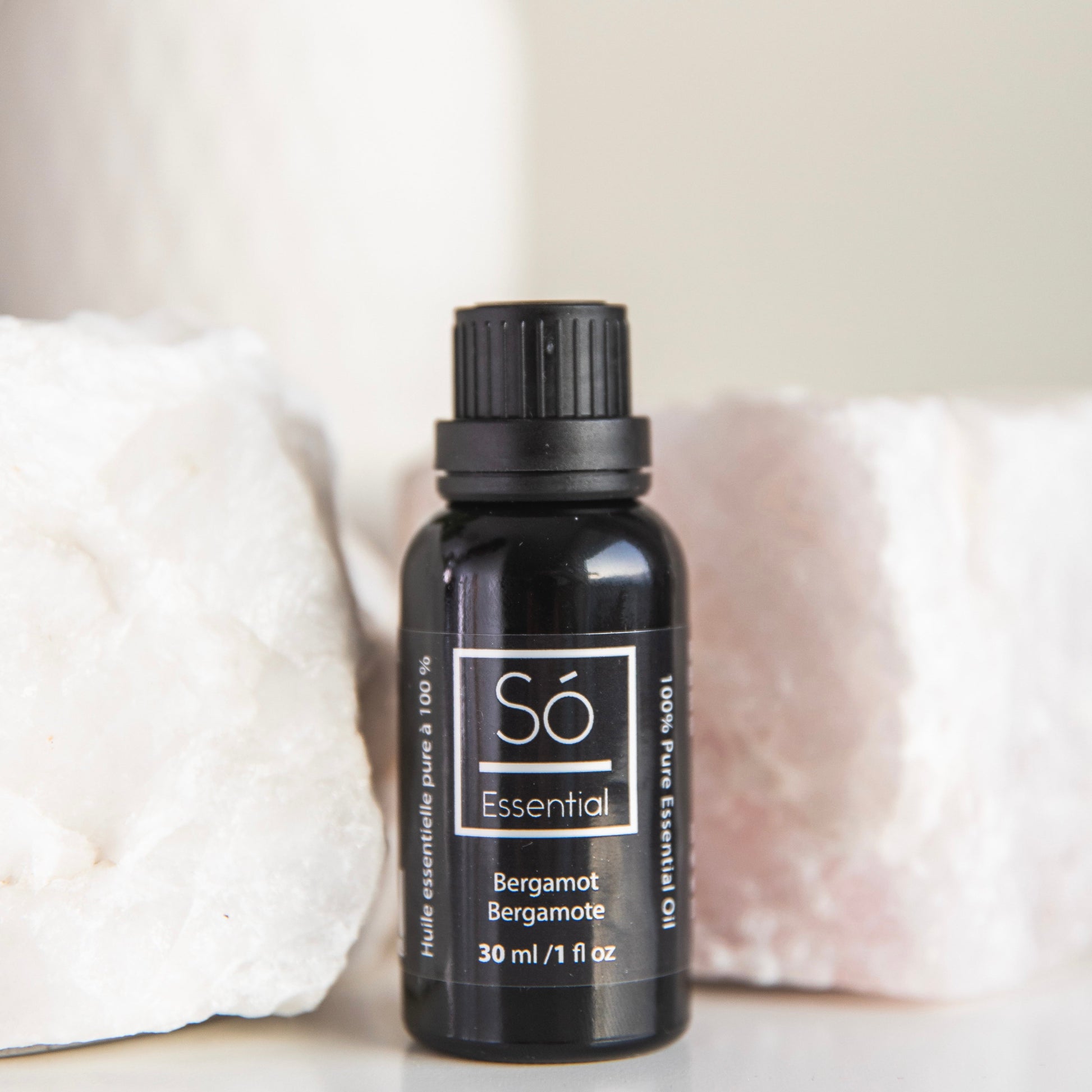 Black Bergamot essential oil bottle labeled 'Sö Essential' on a light background