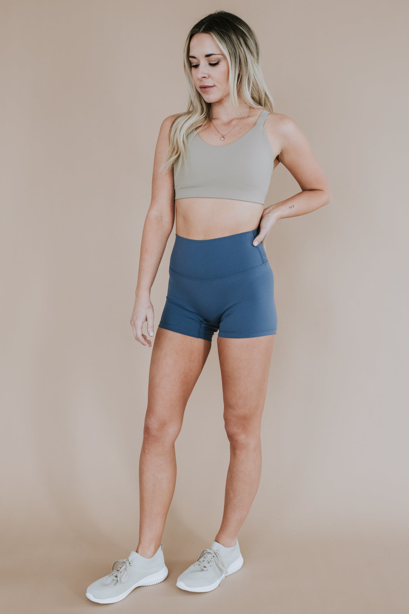 front view of woman wearing barely There 4" yoga shorts in cowboy blue, lightweight squat-proof activewear