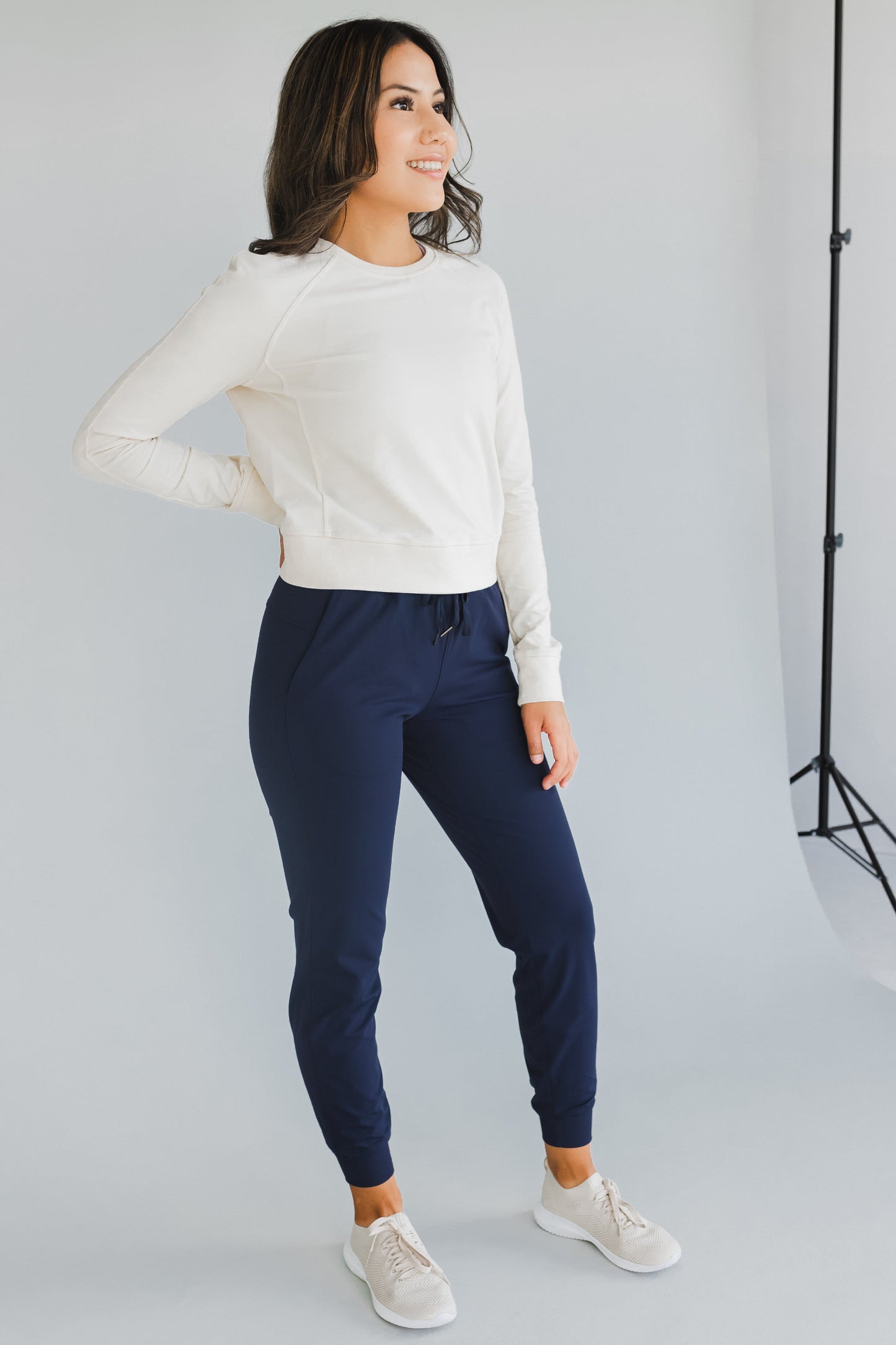 smiling woman wearing cuffed ankle jogger in indigo for workouts and casual wear