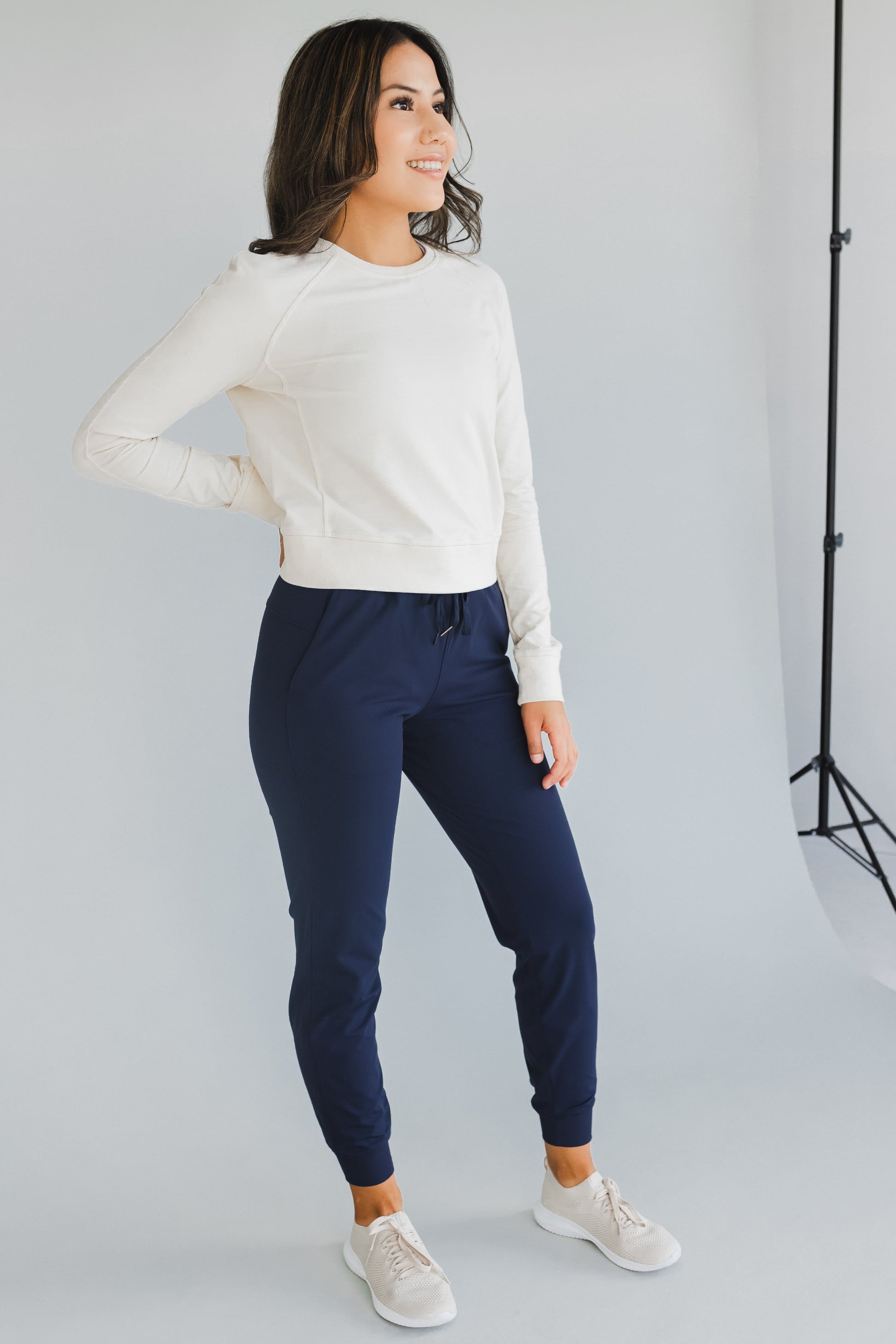 smiling woman wearing cuffed ankle jogger in indigo for workouts and casual wear