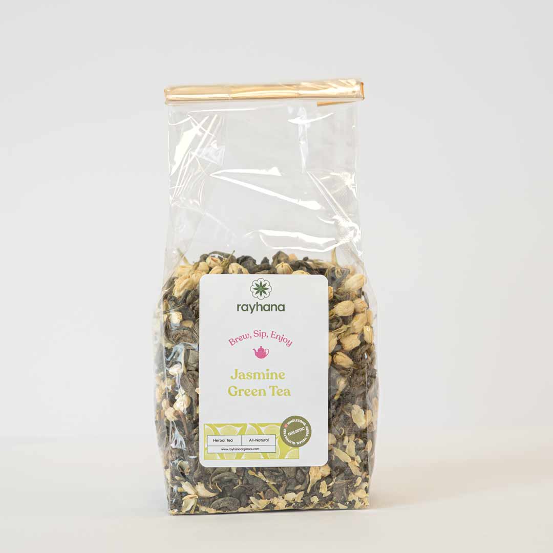 Close-up of dried jasmine blossoms and green tea leaves — fragrant loose blend by Rayhana Organics
