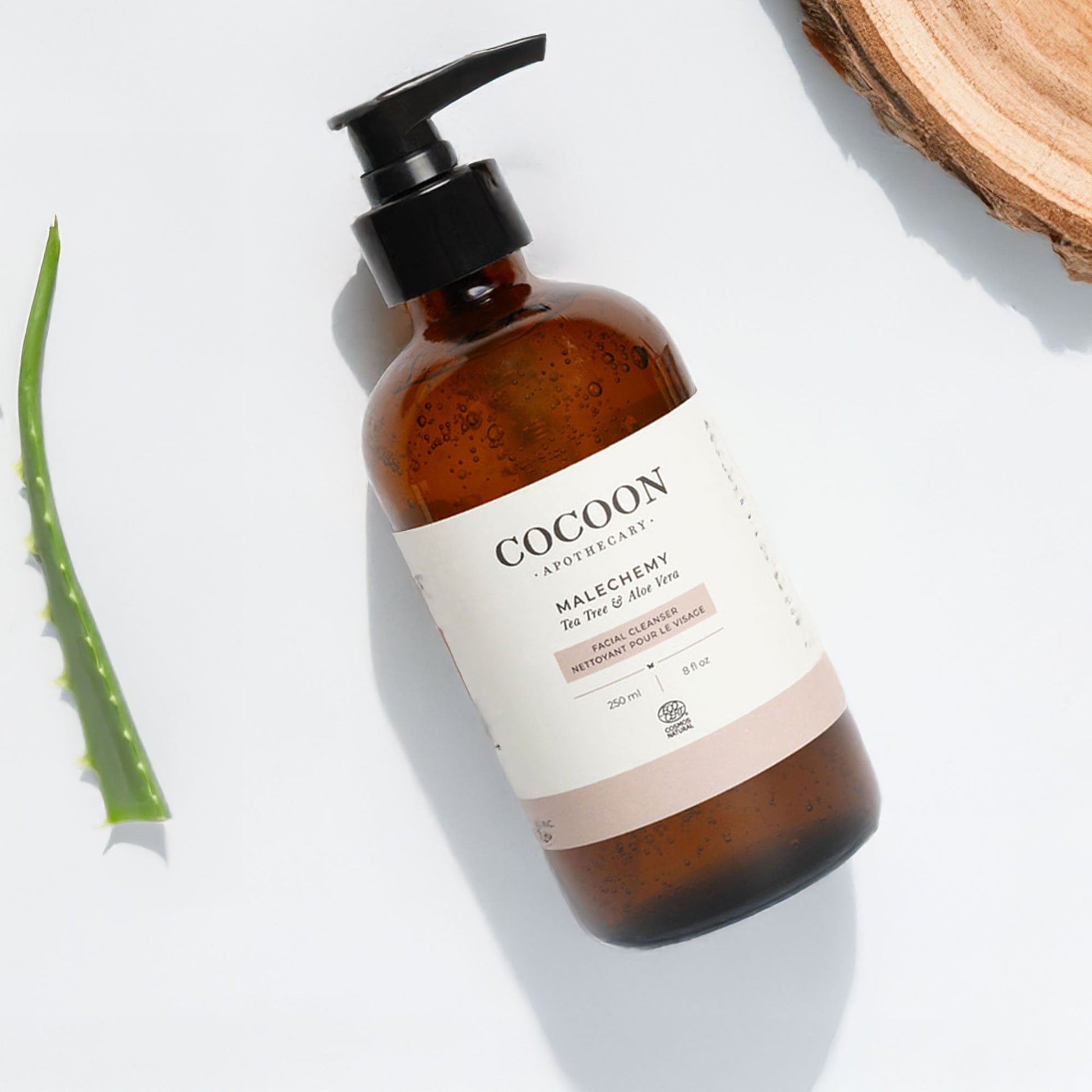 Brown bottle of facial cleanser with pump and 'Cocoon' label on a light background