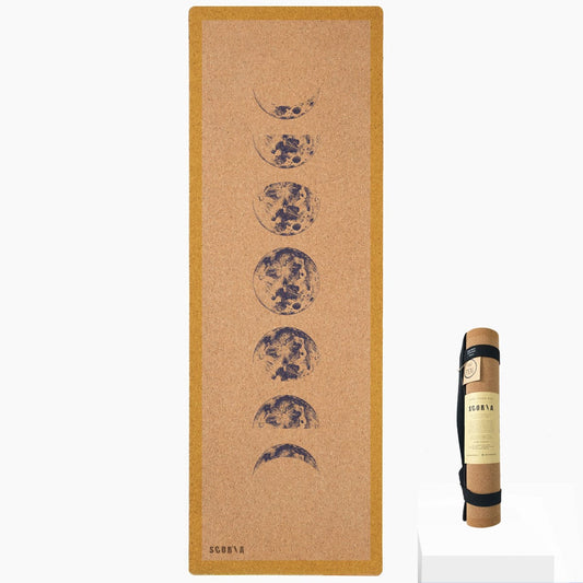 Cork yoga mat with moon phase design and carrying strap on a white background