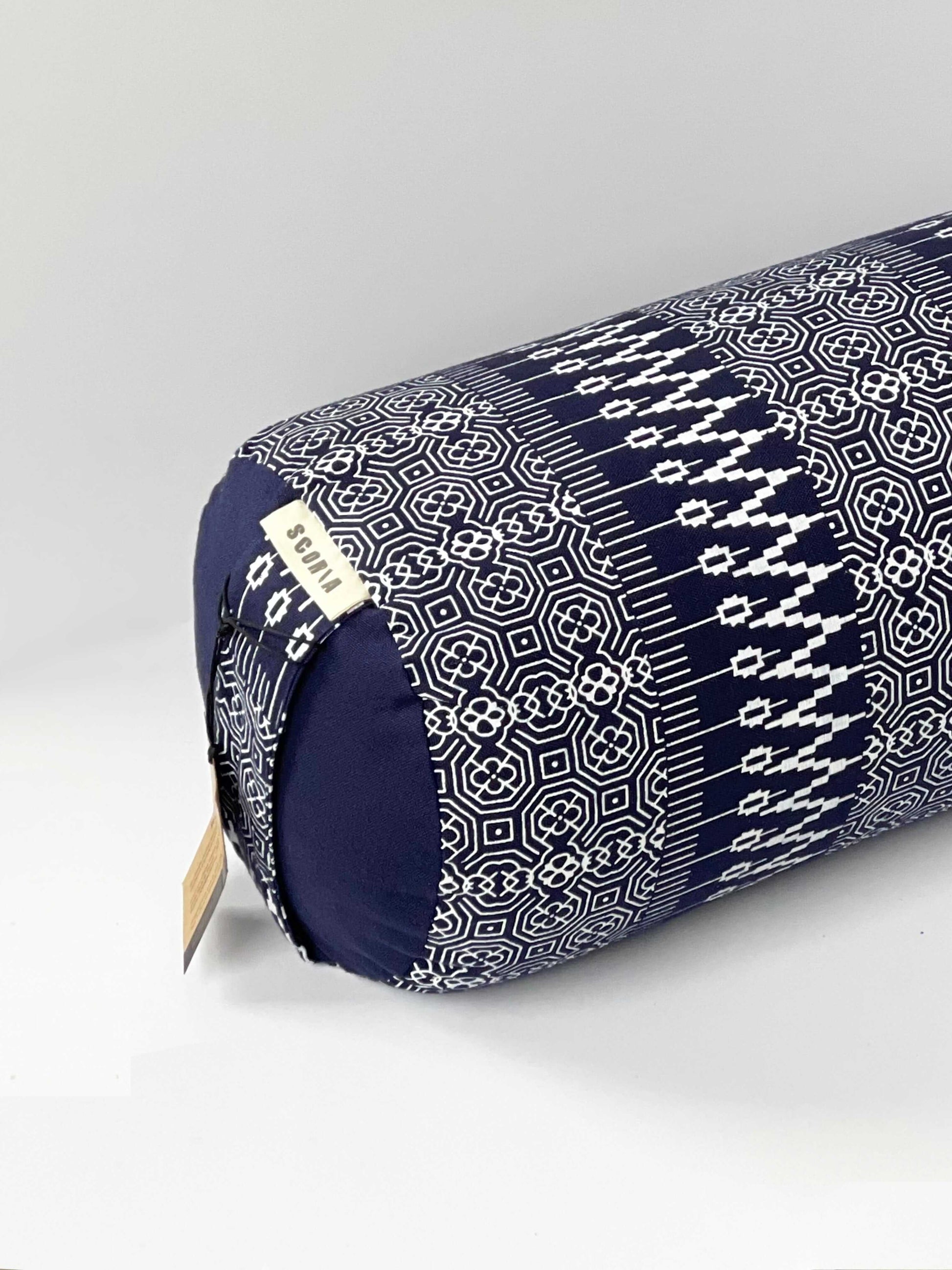 up close view of a navy and white print yoga bolster