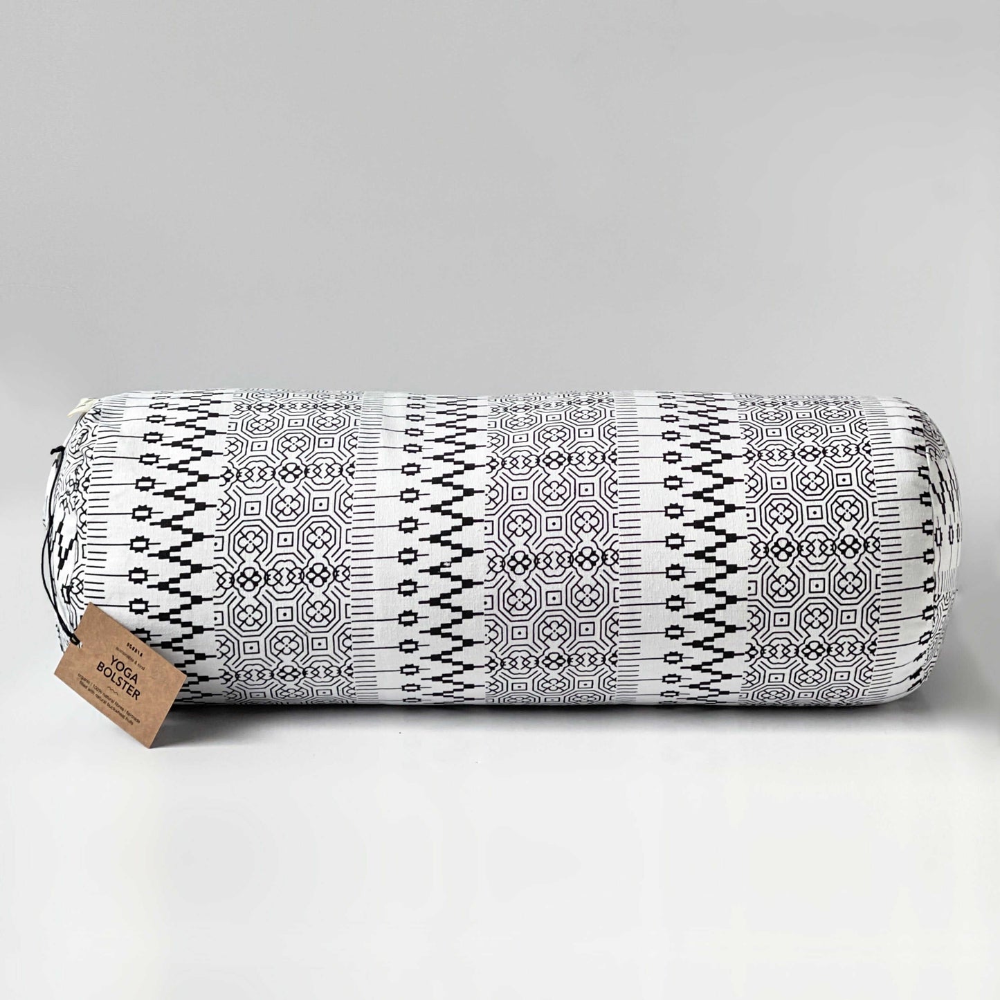 yoga bolster with geometric design and brown tag