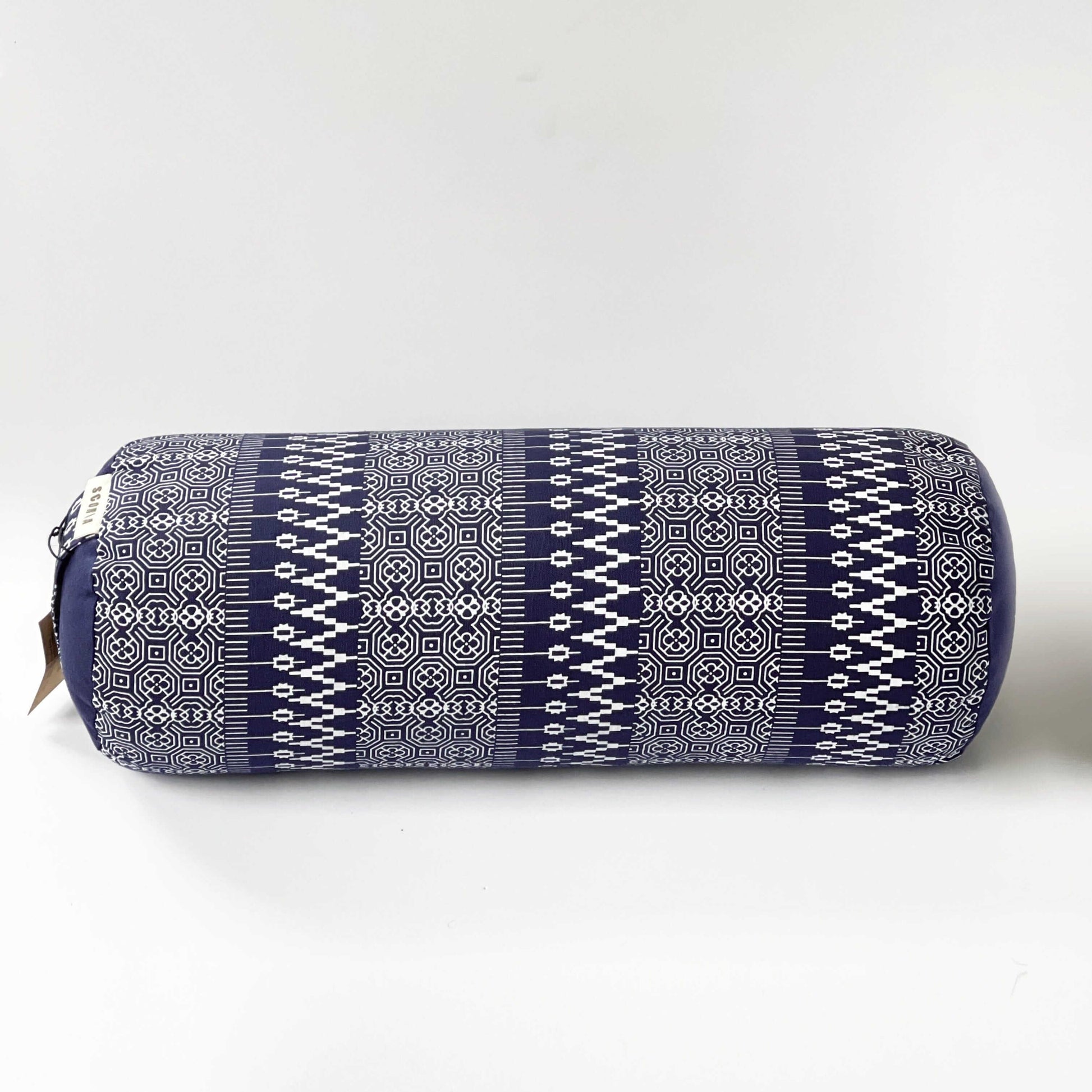 Navy blue cylindrical pillow with white geometric pattern on a white background