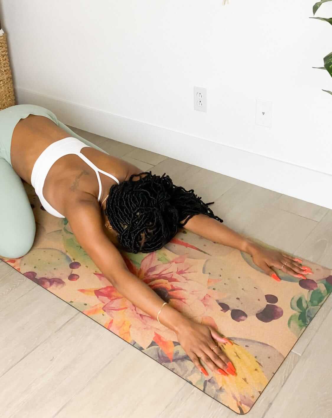Person lying on a colorful yoga mat in a home setting