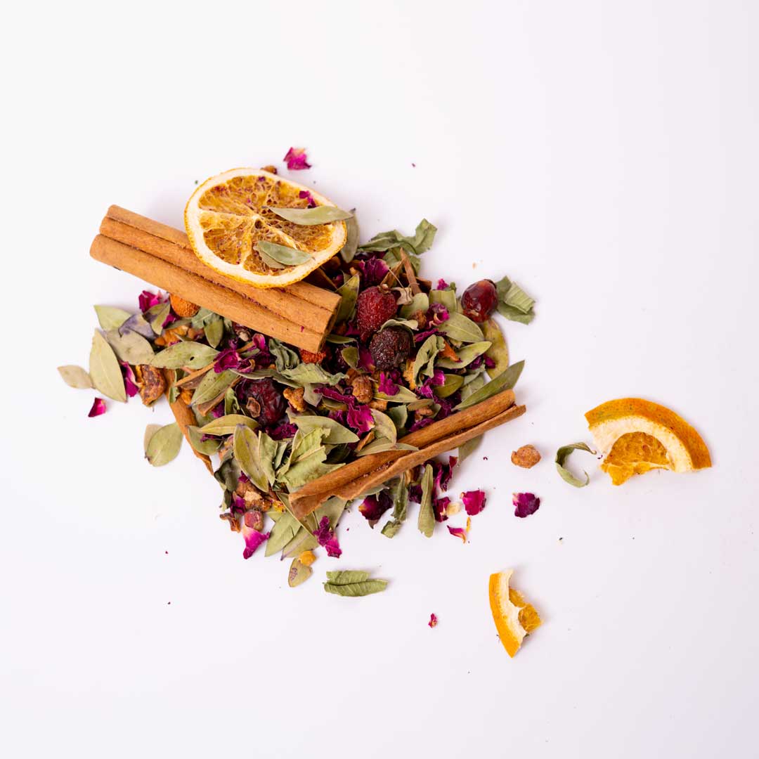 Close-up of dried spice tea blend — cinnamon, clove, and warming herbs for natural wellness